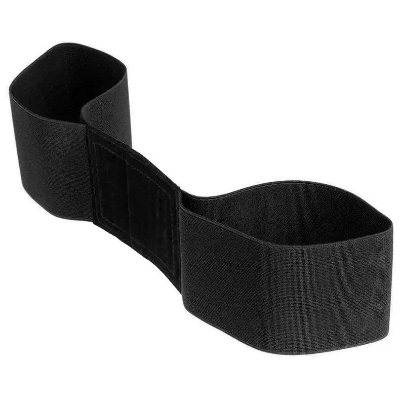 Black elastic golf swing trainer arm band formed into a loop with Velcro section visible on white background.